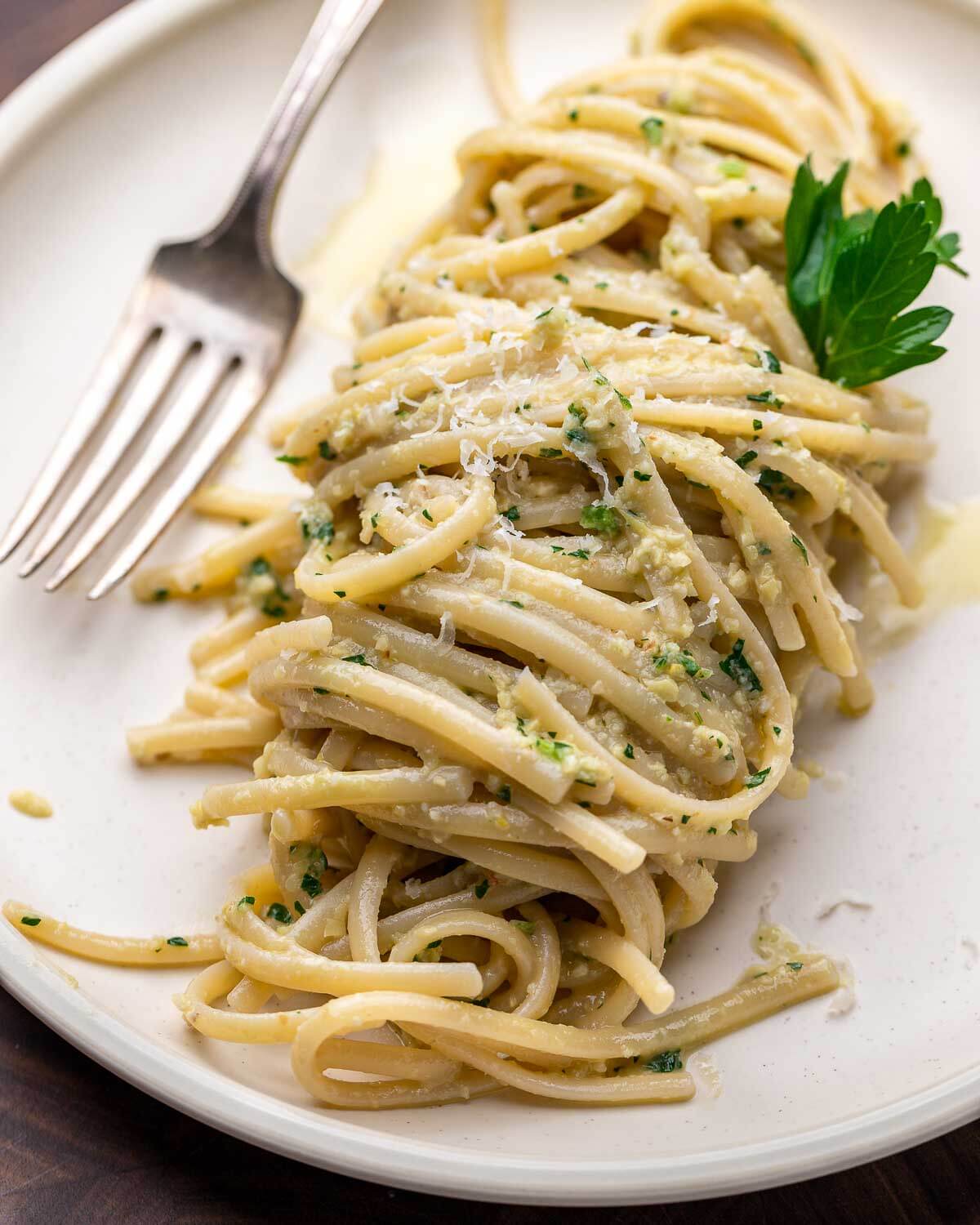 Linguine with artichoke pesto in white plate.