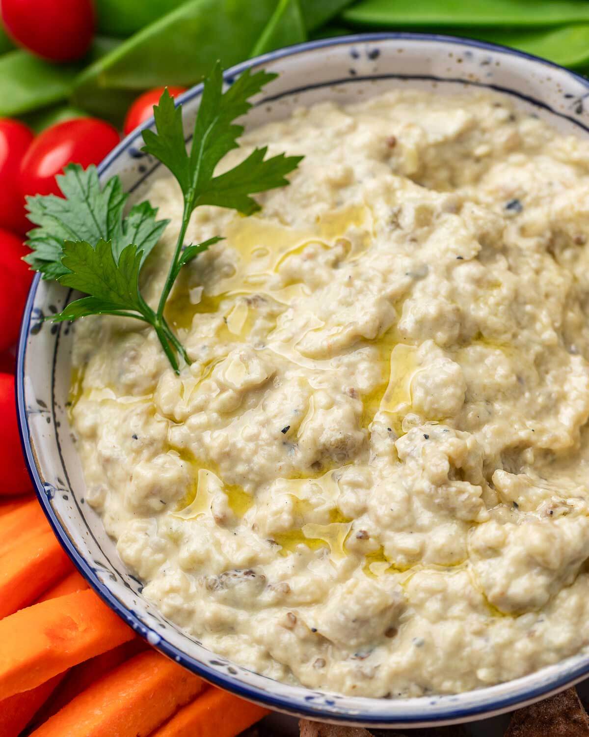 Overhead shot of baba ganoush in white and blue bowl.