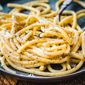 Bucatini cacio e pepe in plate with fork.