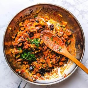 Caponata in pan on white granite countertop.