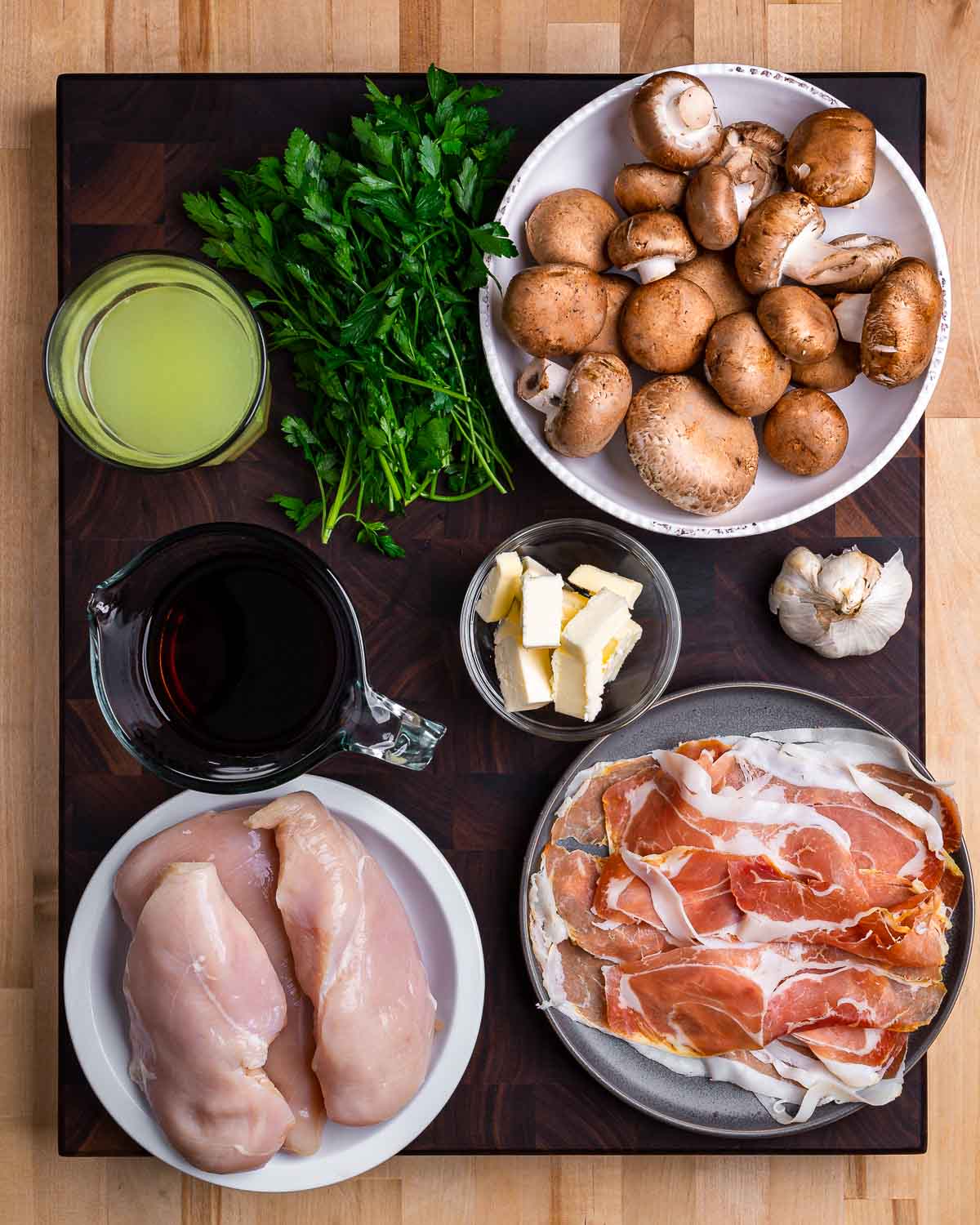 Ingredients shown: chicken stock, parsley, mushrooms, marsala wine, butter, garlic, chicken, and prosciutto.