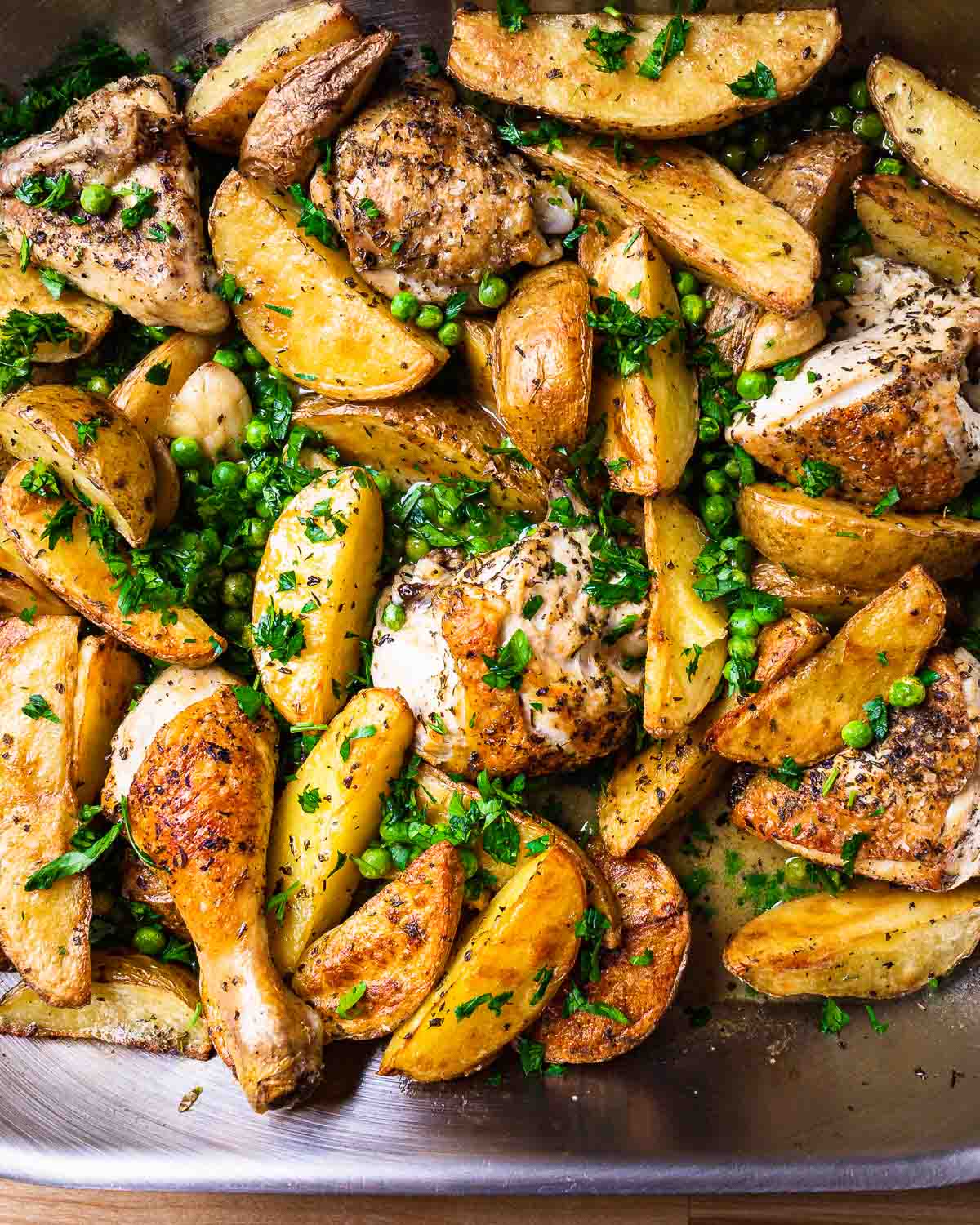 Overhead shot of chicken vesuvio in roasting pan.