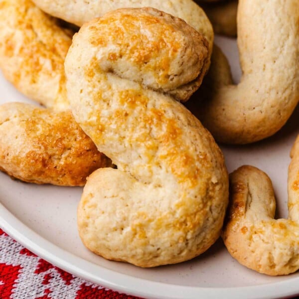 One large Italian S cookie in white plate.