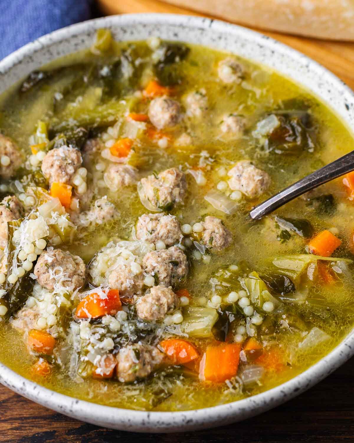 White bowl of Italian wedding soup.