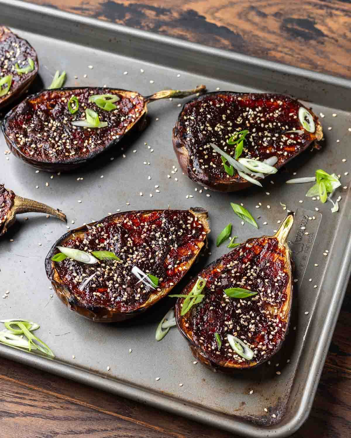 Closeup shot of miso eggplant with sesame seeds and green onions.