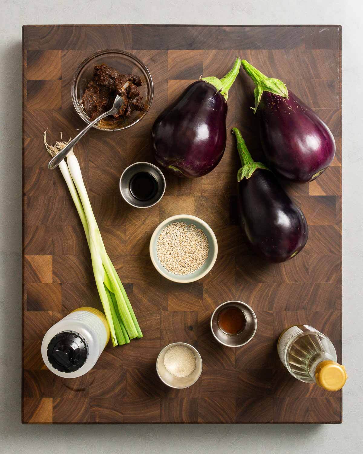 Ingredients shown: red miso paste, eggplants, soy sauce, green onions, sesame seeds, olive oil, sugar, sesame oil, and mirin.