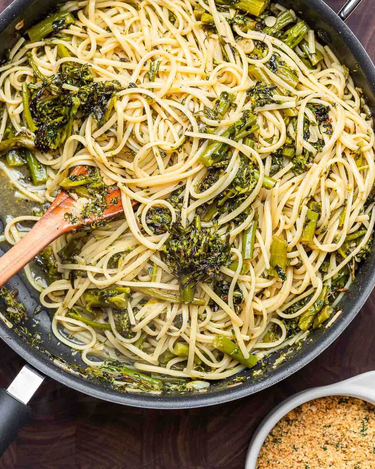 Overhead shot of roasted broccolini pasta on walnut cutting board.