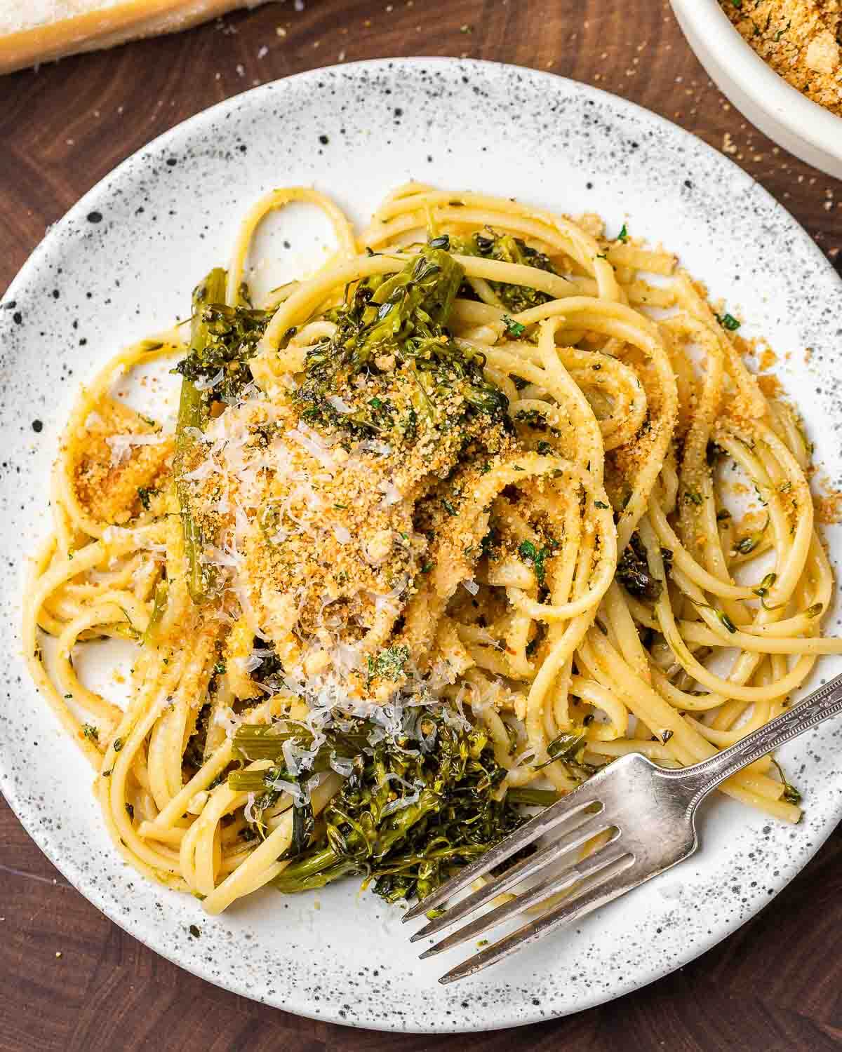 Plate of roasted broccolini pasta topped with toasted breadcrumbs.