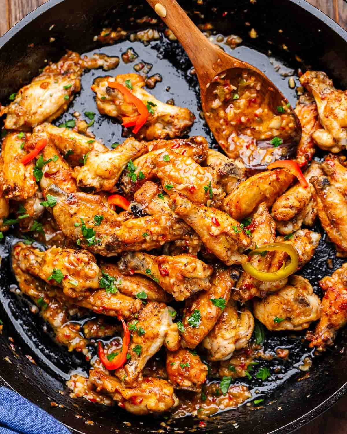 Overhead shot of scarpariello wings in cast iron pan.