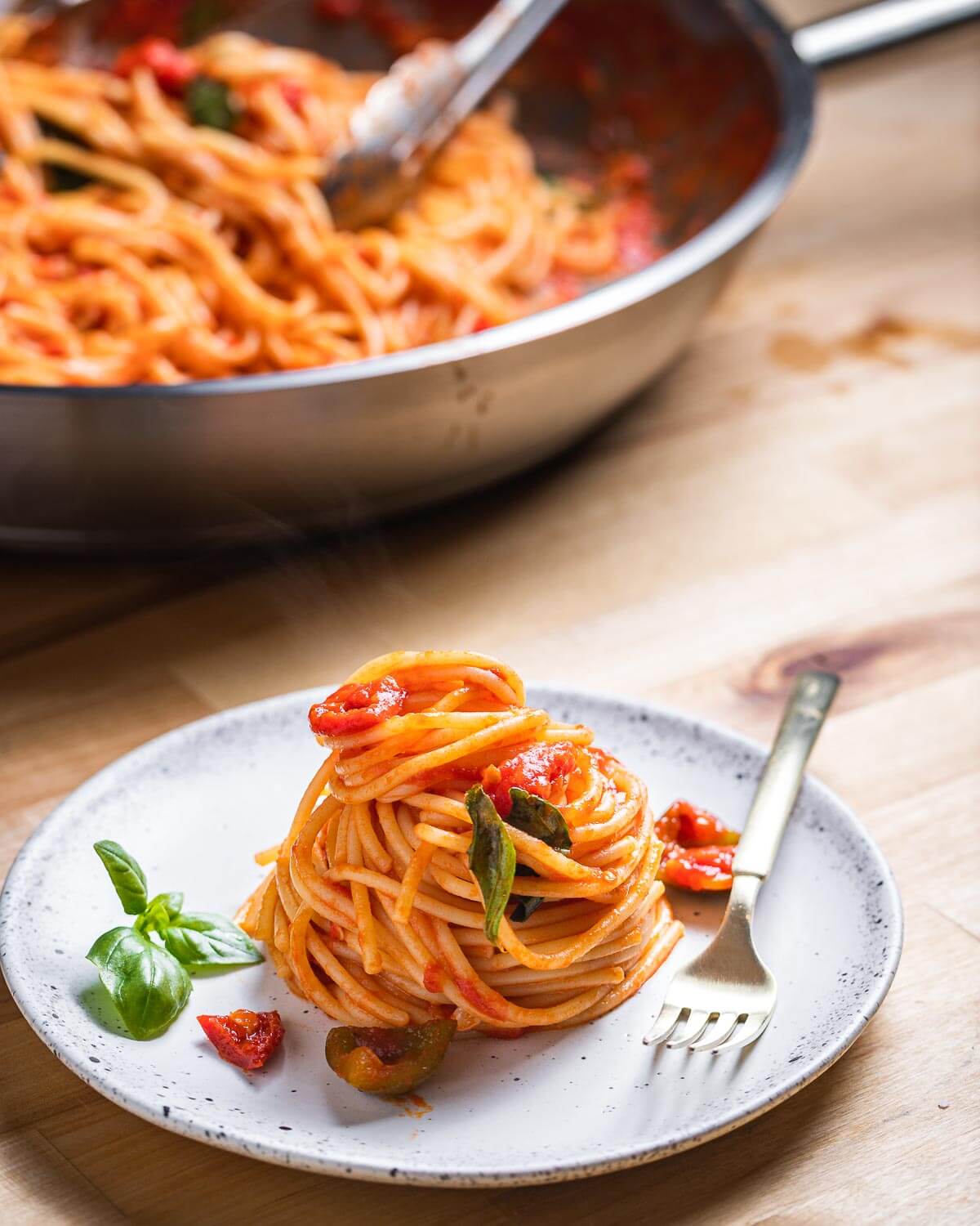 White plate of nested spaghetti arrabbiata.